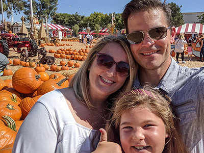 Brigette picking pumpkins with her husband, Steven Davis, and daughter, Kira